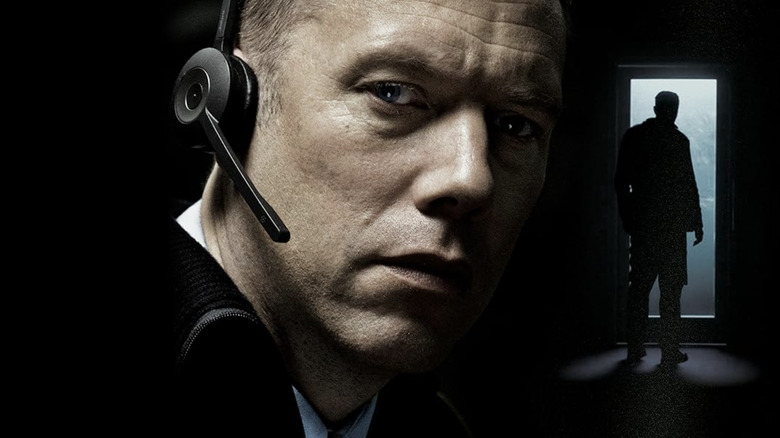 The Guilty poster, showing close-up of Asger Holm in headset and him standing in shadow in front of doorway