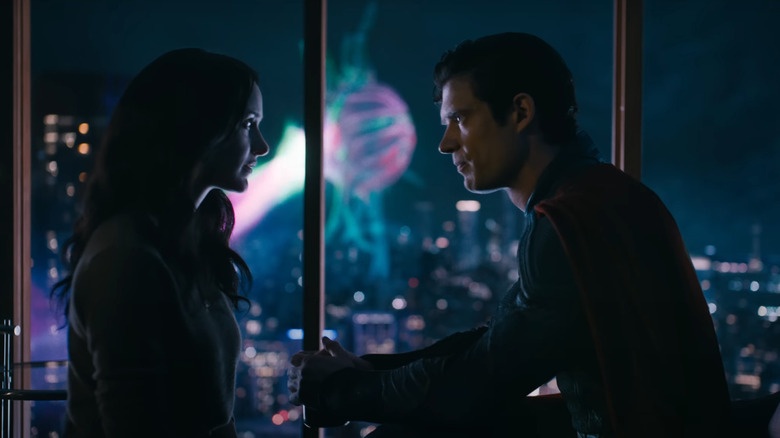 Lois and Clark have a discussion while battle rages in the background in Superman