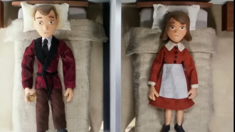 Clay and Roberta Puppington lay in their respective beds with a divider keeping them apart, both looking miserable while Clay holds a glass of scotch in his hand, in "Moral Orel"