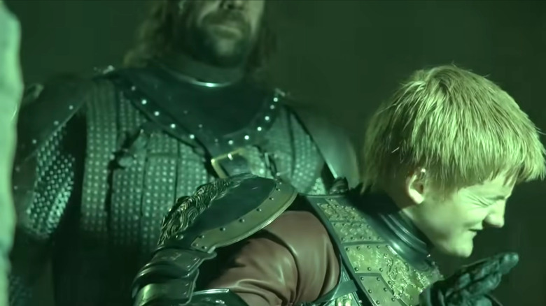 Game of Thrones, Joffrey shielding his eyes from the wildfire explosion while the Hound watches behind him