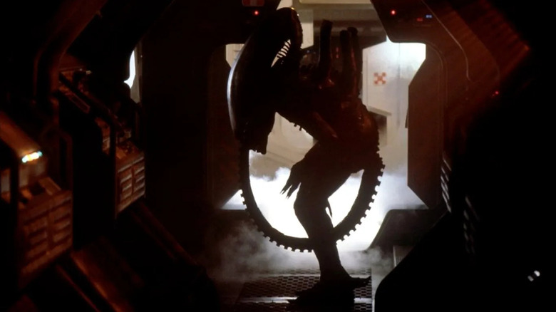 The creature lurking in a hallway in Alien