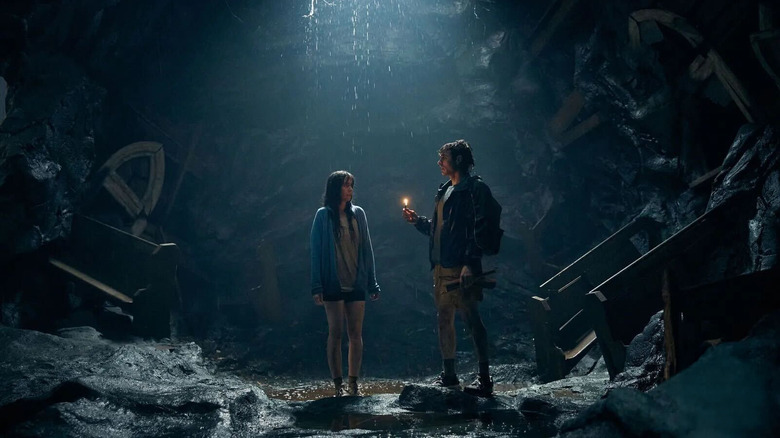 Millie and Tim standing in a cave in Together