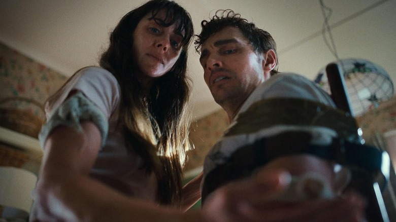 Millie and Tim trying to detach from one another in Together