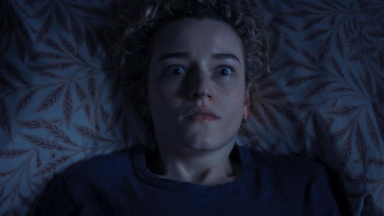 Julia Garner as Justine waking up in shock in the middle of the night in Weapons