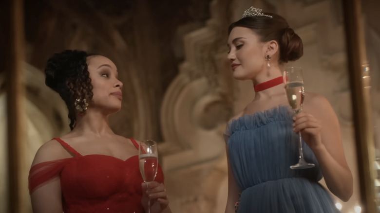 Sisi Stringer's Rose Hathaway stands opposite Daniela Nieves' Lissa Dragomir while holding a champagne glass in Vampire Academy